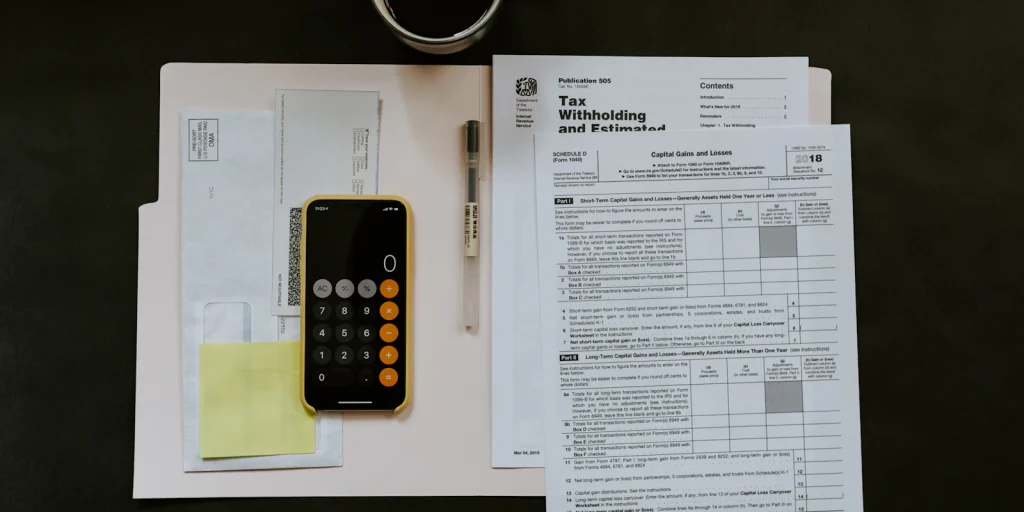 Smartphone, pen and invoice paperwork on a desk